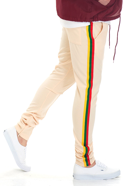 Beige track pants with vertical multicolor stripe down side and elastic cuffs