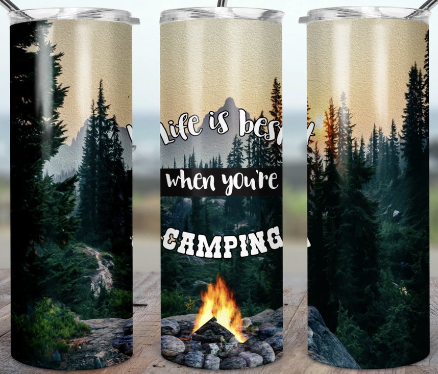Stainless steel camping tumbler with forest trees and campfire graphic
