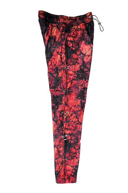 Red and black graphic joggers with elastic waistband and side toggle cords.
