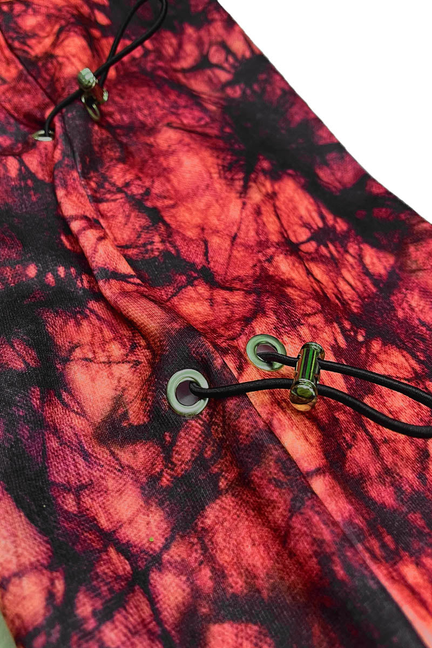 Red and black graphic sweat fabric detail with side toggle eyelets and cords.