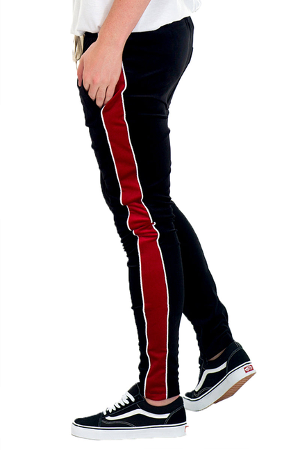 Black velvet pants with red side stripe, drawstring waist and tapered fit