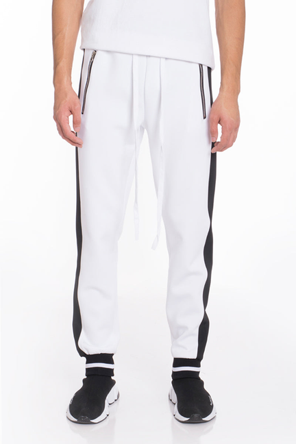 White jogger track pants with black side stripes and elastic ankle cuffs