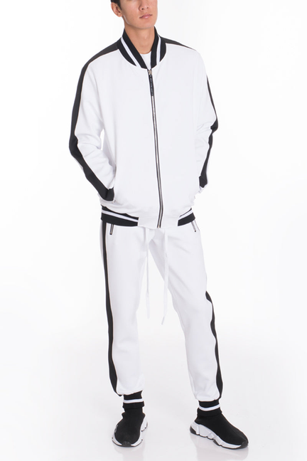 White track set with zip jacket and tapered jogger pants, black side stripes