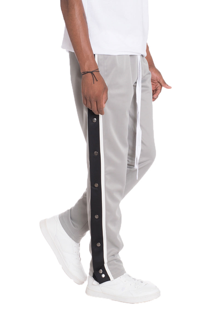 Grey snap-button track pants with black side stripe
