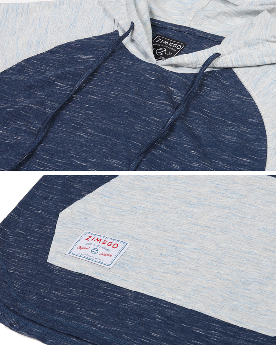 Raglan hoodie fabric close-up with hood trim; light blue patch over dark navy