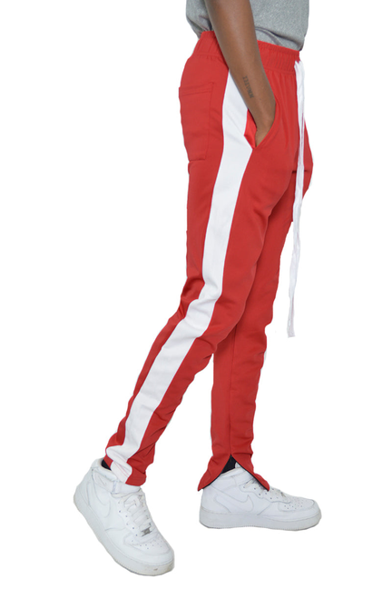 Red slim-fit track pants with white side stripe and cuffed ankle hem