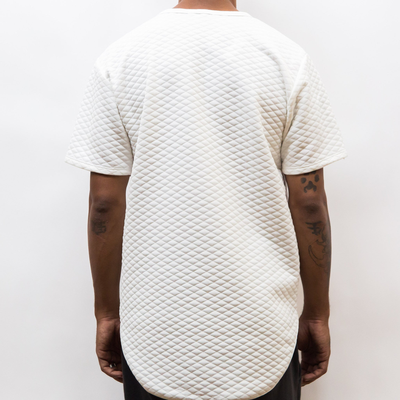 White quilted scallop tee, back view with curved hem