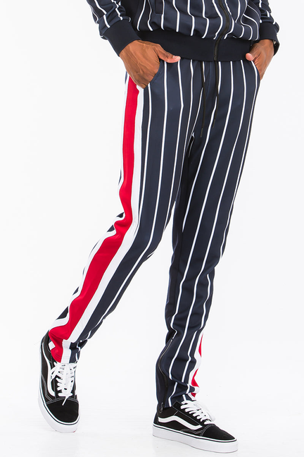 Navy pinstripe track pants with red side stripe and white piping