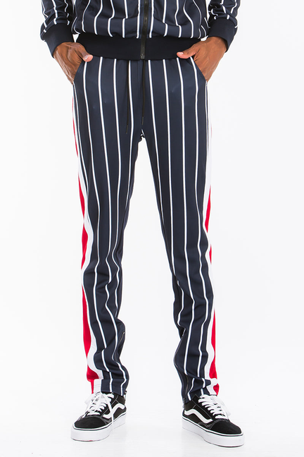 Navy pinstripe track pants with white lines and red side panels