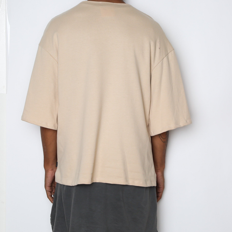 Sand-beige slouch T-shirt, crew neck, short sleeves, relaxed fit; back view.