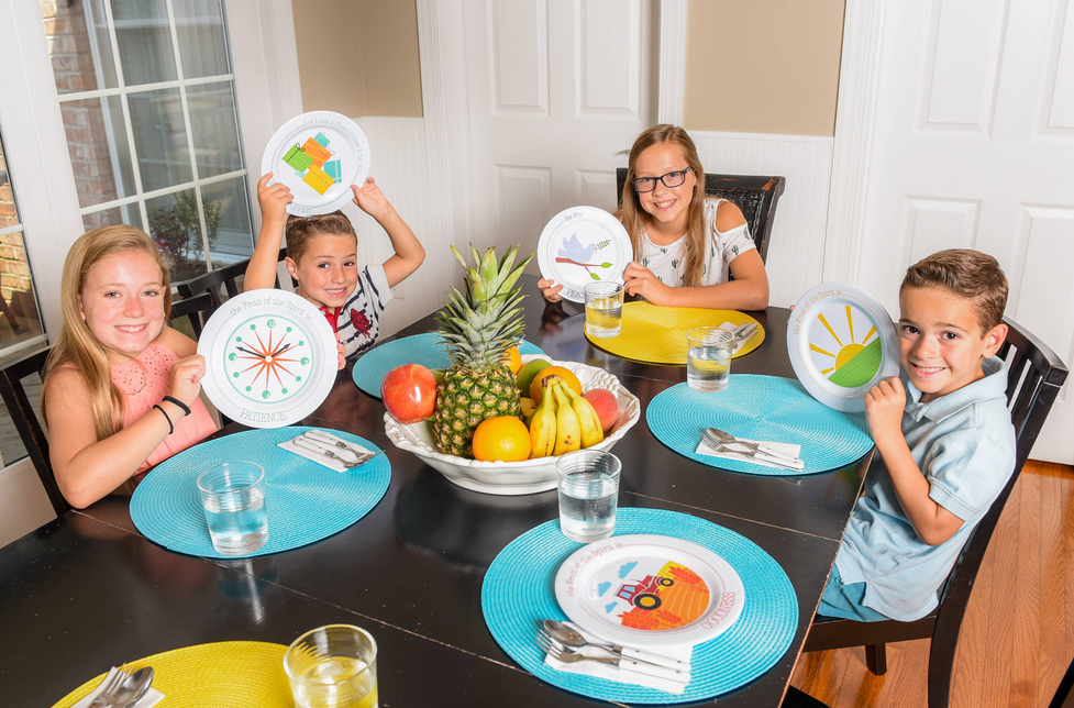 Joy Plate round plate with sun “Joy” design on dining table