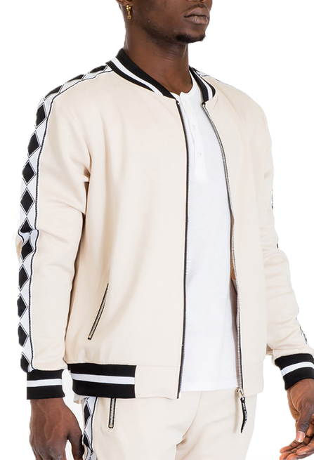 Beige track jacket with diamond tape trim, black-and-white ribbed cuffs, front zipper