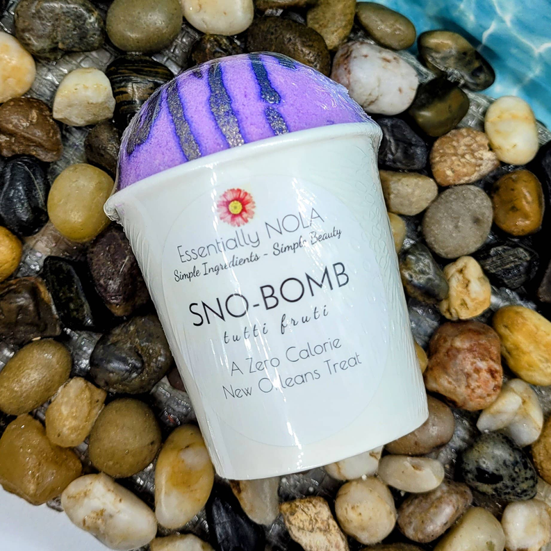 Tutti frutti bath bomb in white cup, purple-and-violet striped top