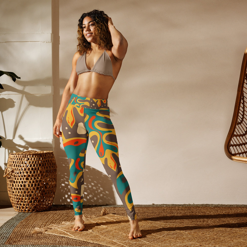 Yoga leggings with abstract teal and orange flame print on dark brown.
