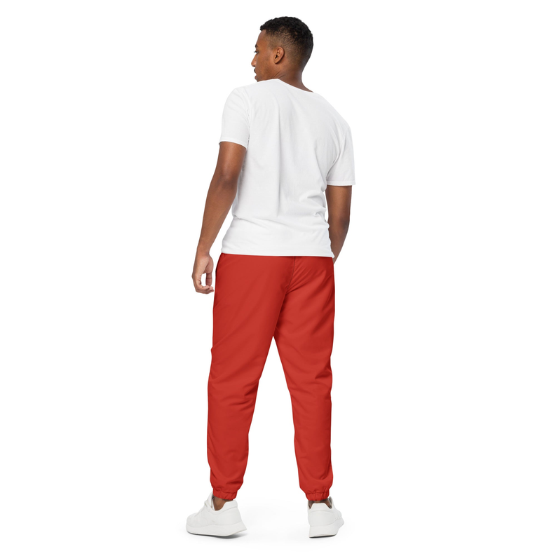 Red track pants, back view, with tapered legs and elastic cuffs