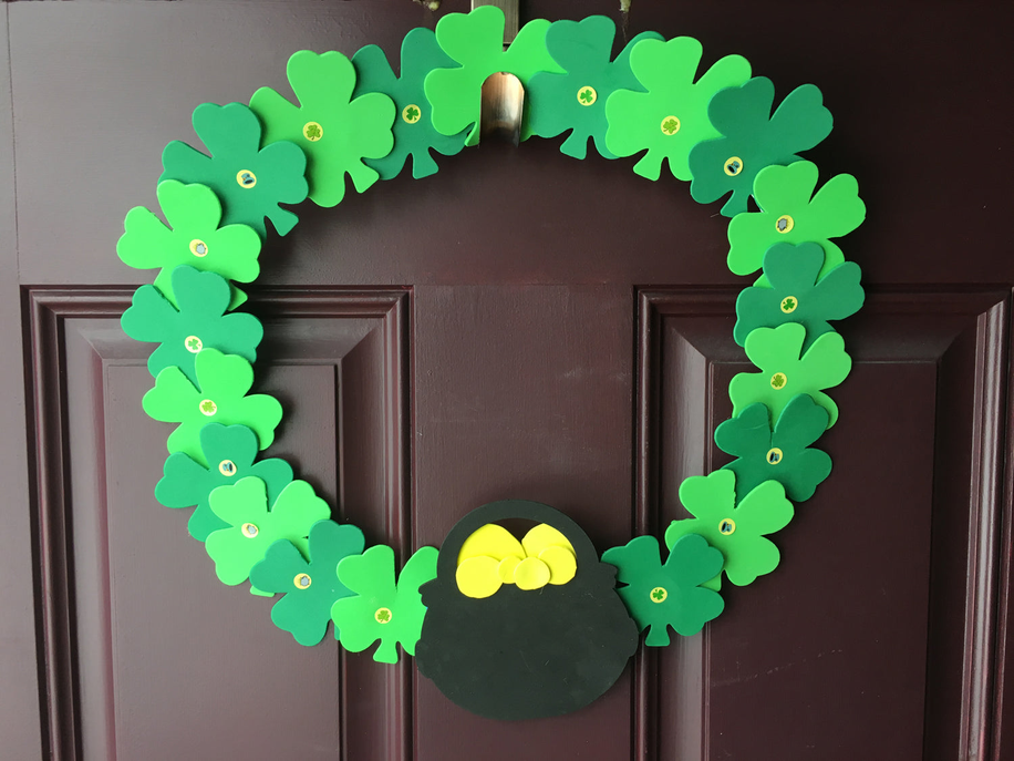 Green shamrock foam wreath cut-outs with a yellow heart center and small dots