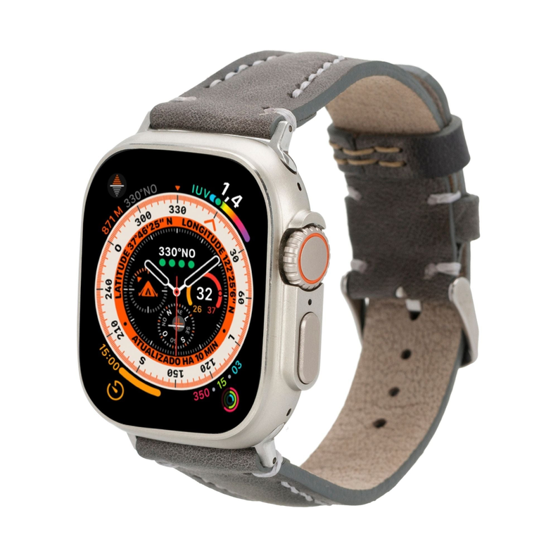 Gray leather Apple Watch band with perforation holes; worn with watch