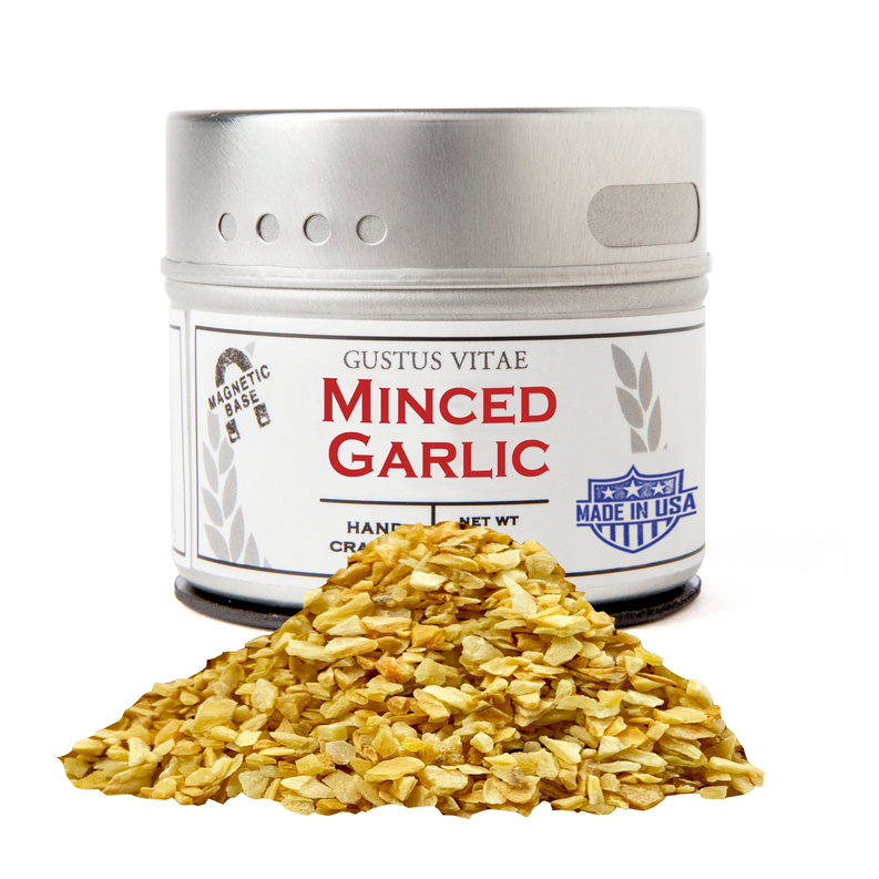 Minced garlic tin with silver lid and pile of minced garlic