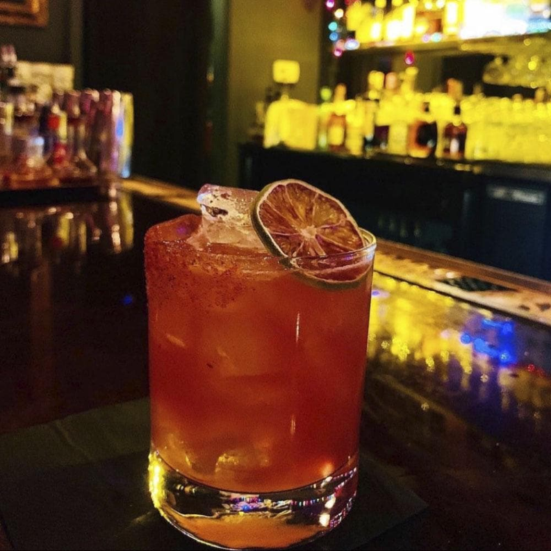 Infused cocktail cane sugar used in a citrus cocktail glass on a bar