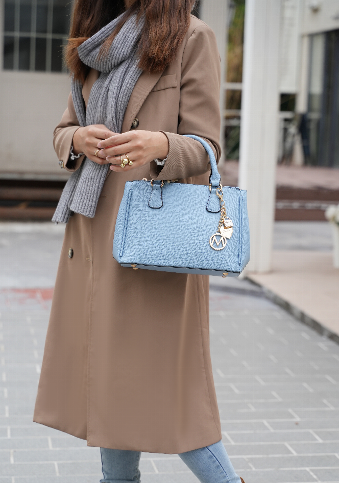 Light blue vegan leather satchel bag with top handles, chain charm, and wallet pocket