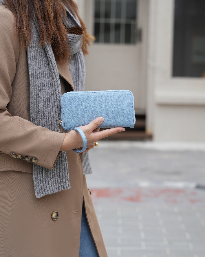 Light blue vegan leather wallet pouch with wrist strap, flat clutch shape