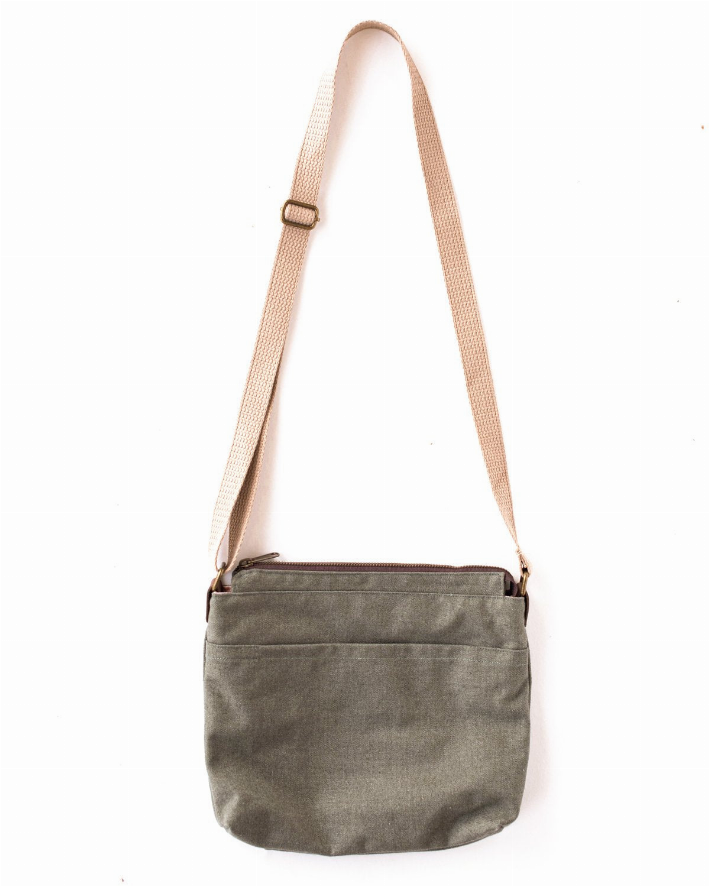 Olive crossbody bag with adjustable canvas strap and zippered main compartment