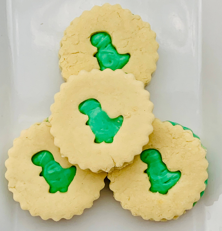 Dino Oreo sandwich cookies with three green dinosaur cream centers