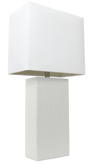 White geometric fabric table lamp shade with dark trim on textured white pedestal base