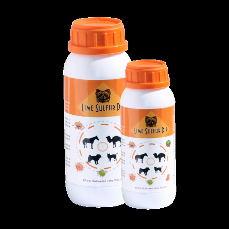 Two lime sulfur dip solution bottles with orange caps on a dark background