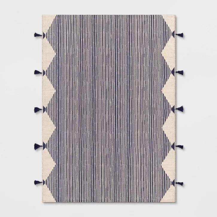 7x10 outdoor area rug with navy and ivory linear stripes and corner tassel fringe