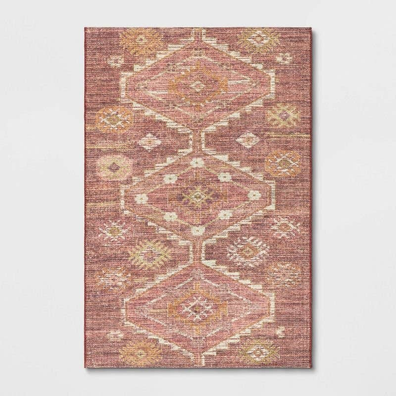Rust diamond Persian-style area rug with symmetrical medallion geometric design