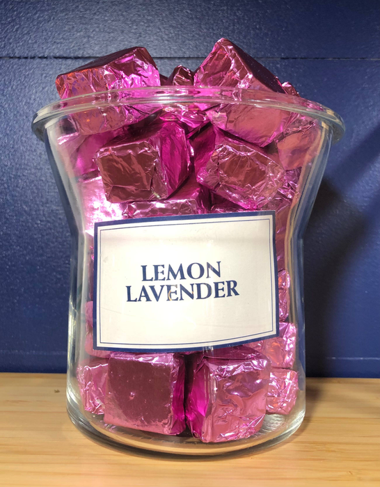Glass jar filled with lemon lavender purple foil-wrapped bath rocks