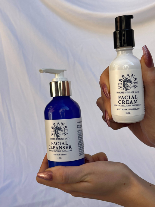 Vibransea hyaluronic acid facial cream bottle held in hand with black pump, 2 oz