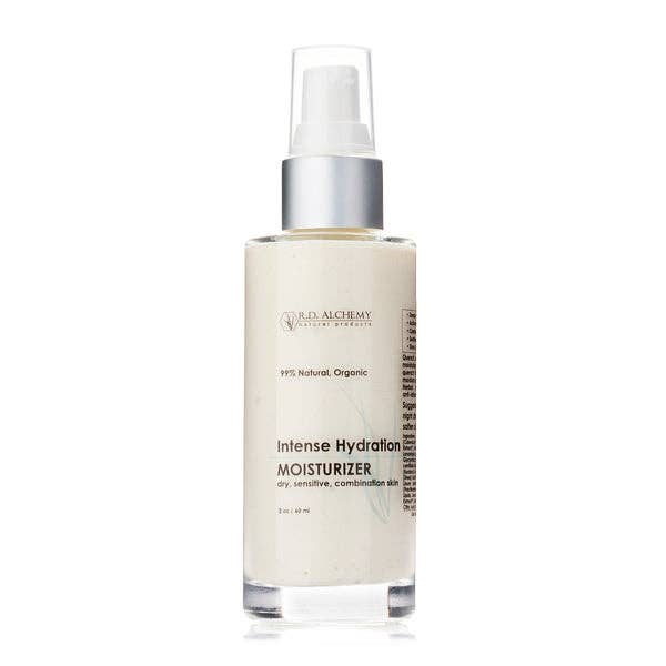 Beige moisturizing cream bottle with silver pump, minimalist label on frosted glass