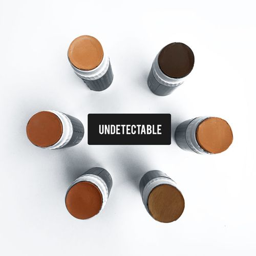Concealer stick caps showing light to dark brown shades in silver bases