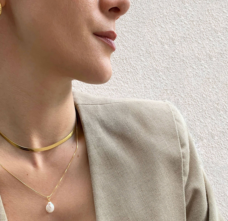Layered gold-tone pearl pendant necklaces with teardrop pearl and slim chain