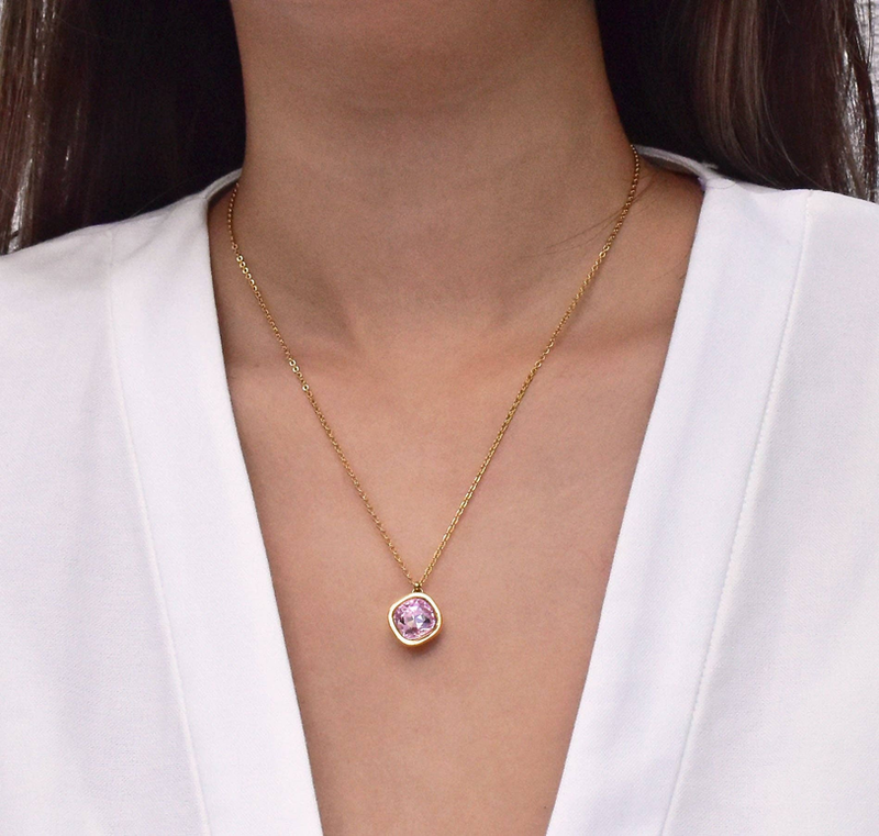 Gold round pink amethyst pendant on fine chain, worn on the neckline
