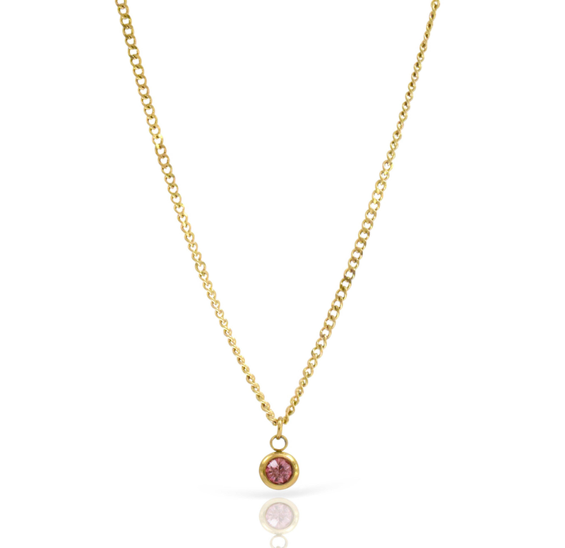 Gold chain pendant necklace with centered round pink gemstone charm