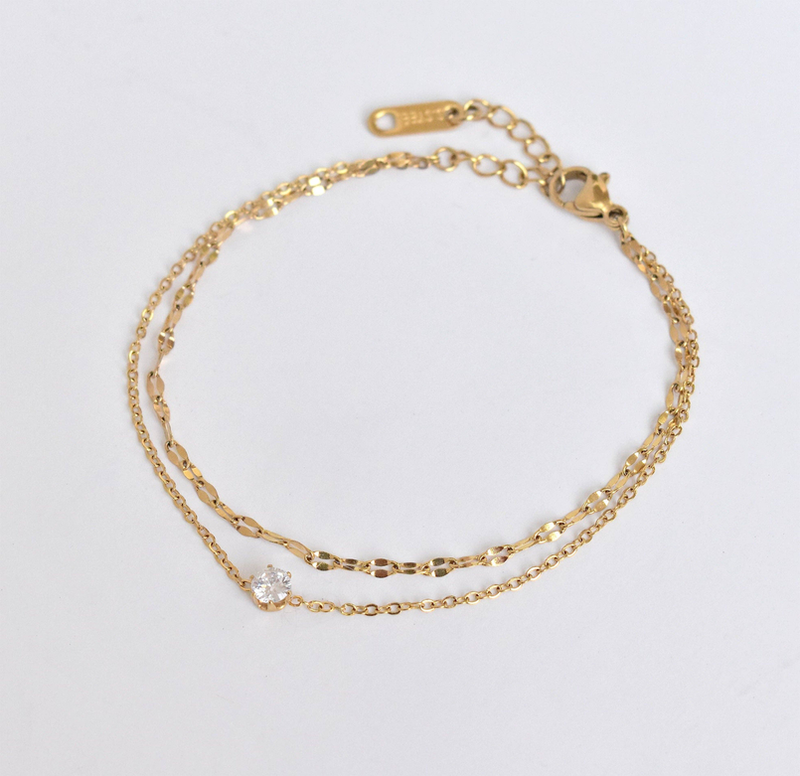 Gold layered solitaire bracelet set with tiny round clear stones and clasp