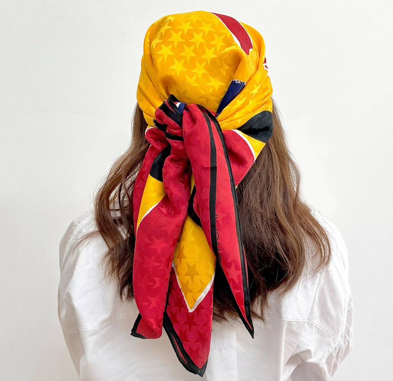Yellow, pink and dark blue silk scarf with star pattern, tied around hair