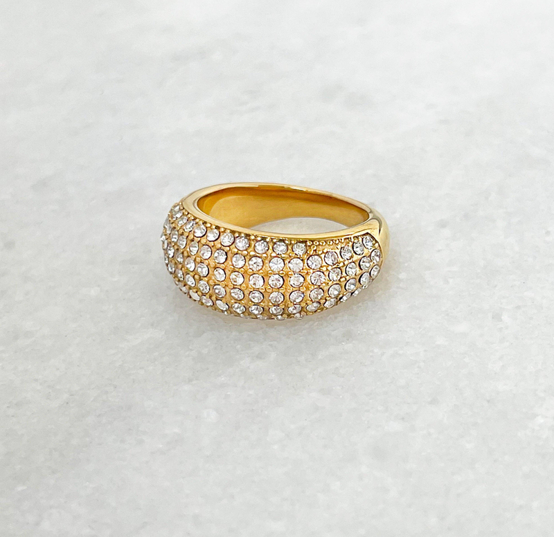 Gold-tone dome pave ring with closely set round crystals, front view
