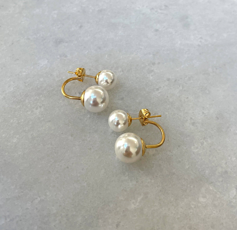 Gold-tone double pearl ear jacket stud earrings with two round white pearls and gold posts