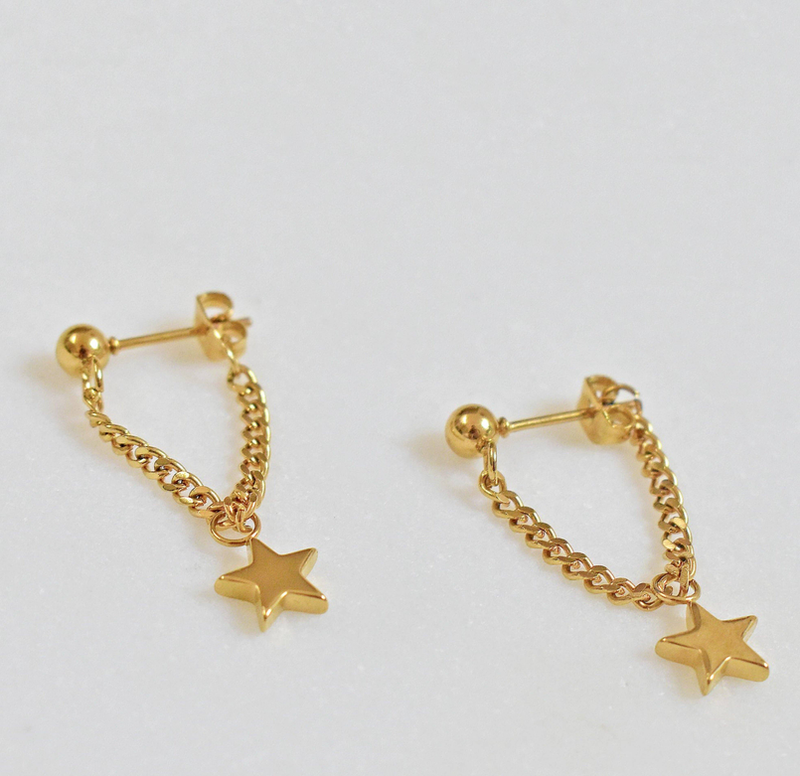 Gold hoop chain earrings with star charm dangles, angled view of the pair.