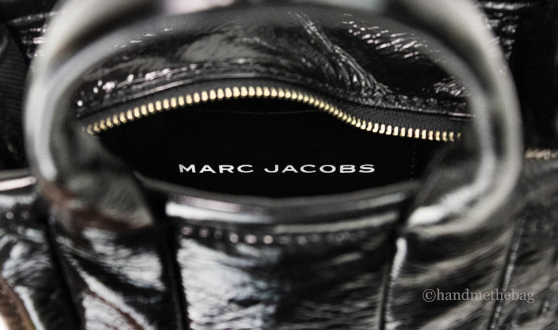 Marc Jacobs micro tote zipper pull and embossed logo on glossy black leather