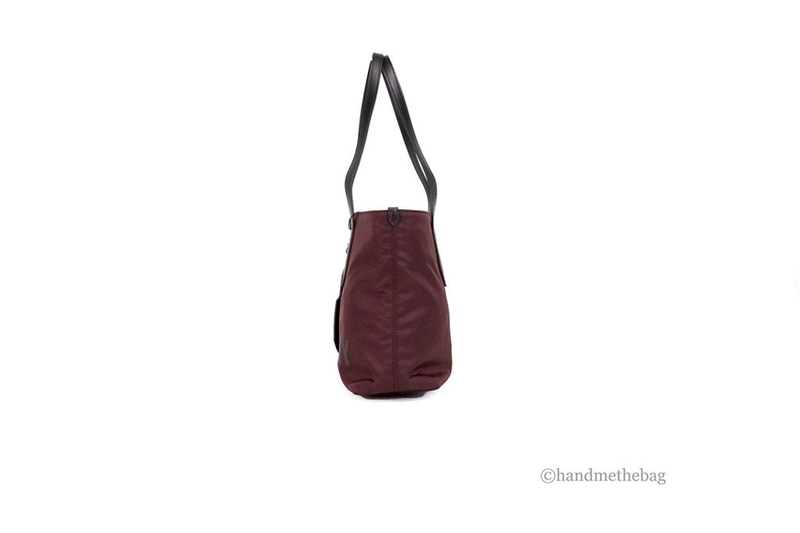 Burgundy compact nylon tote bag with short top handles, small rounded shape