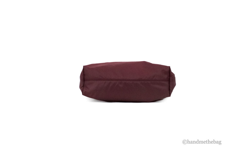 Burgundy nylon tote bag with structured base and clean, minimal side profile