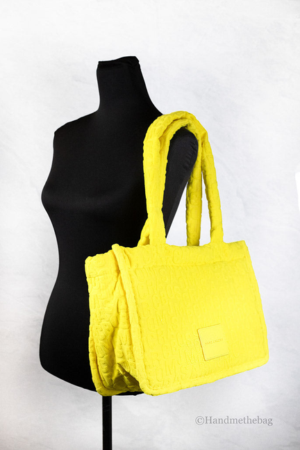 Medium bright yellow terry monogram tote bag with two top handles, shown on mannequin