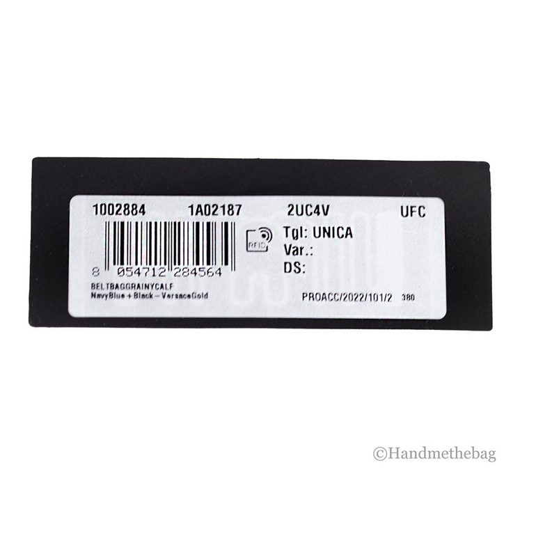 Product label tag on navy/blue leather fanny pack with barcode and serial info