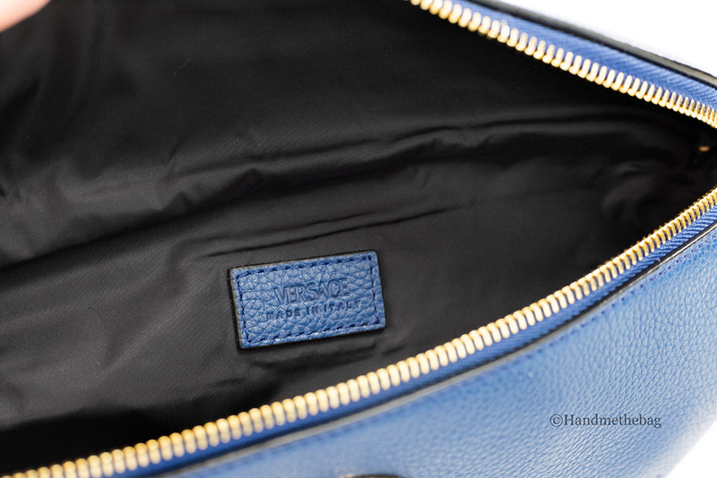 Inside view of blue leather fanny pack with Versace logo patch and gold zipper