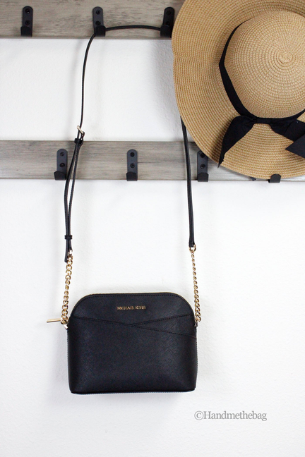 Black medium crossbody bag with long gold-tone chain strap and top zipper